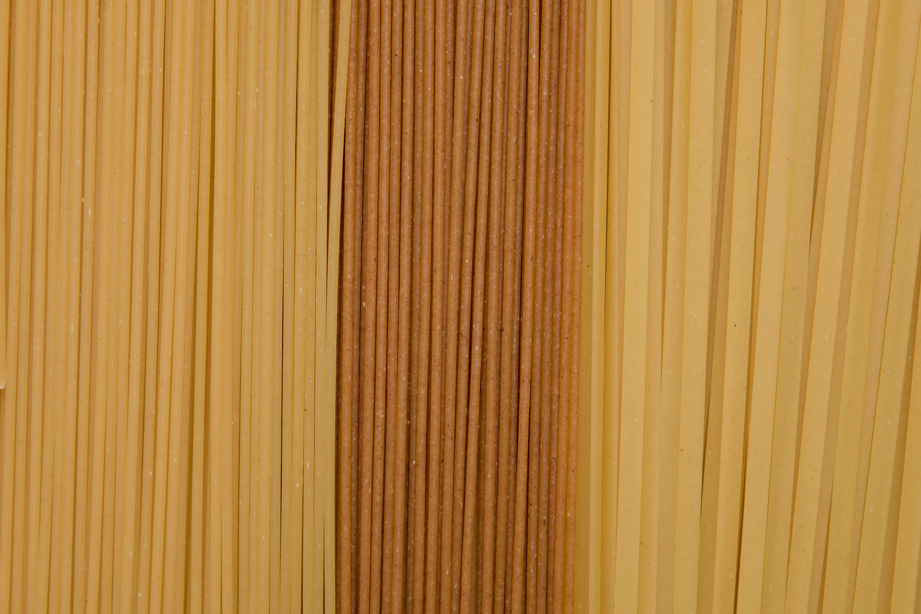 A close-up of assorted dried noodles showcasing texture and color diversity.