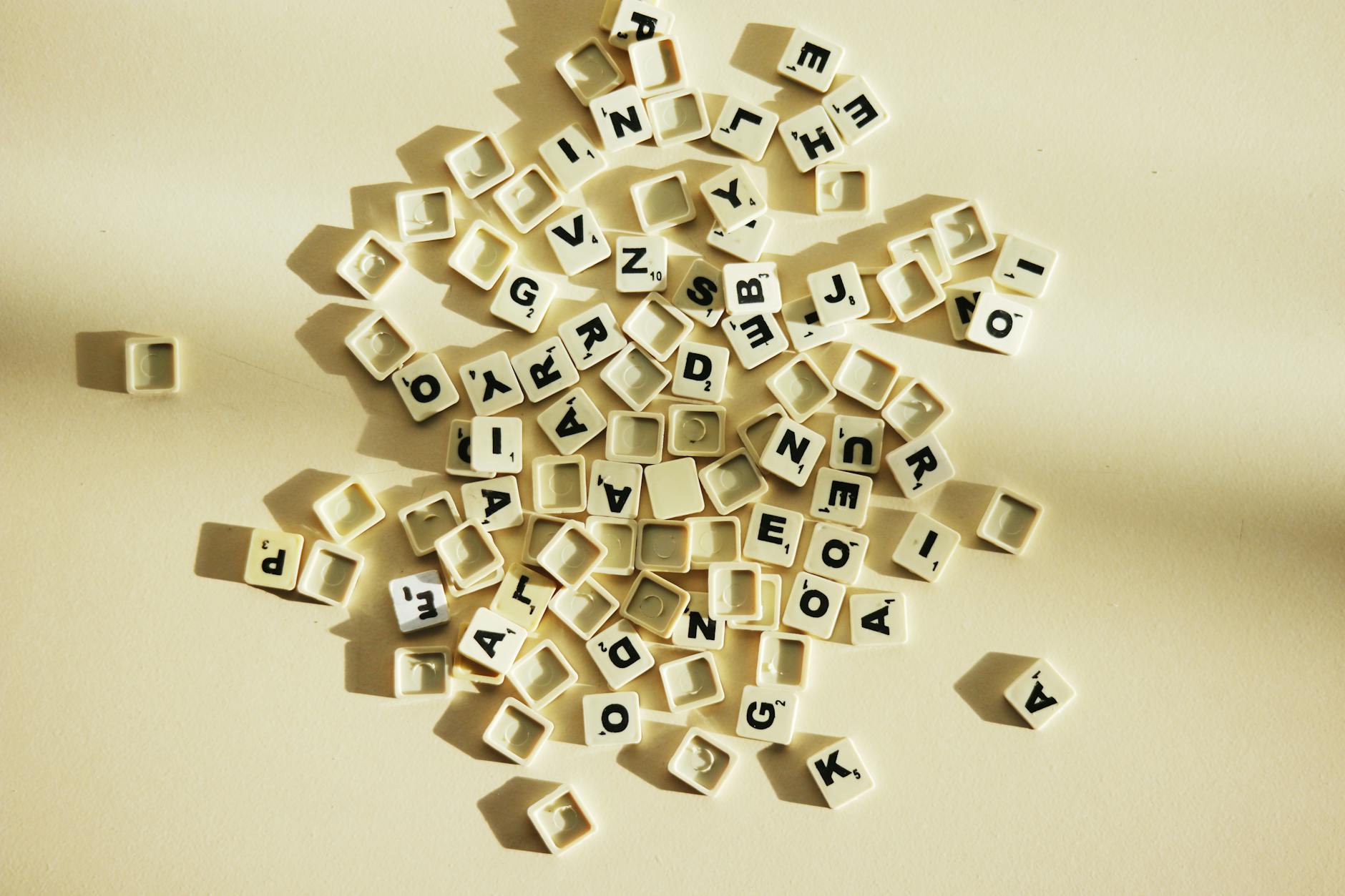 A close-up view of scattered letter tiles on a light surface, ideal for educational themes.